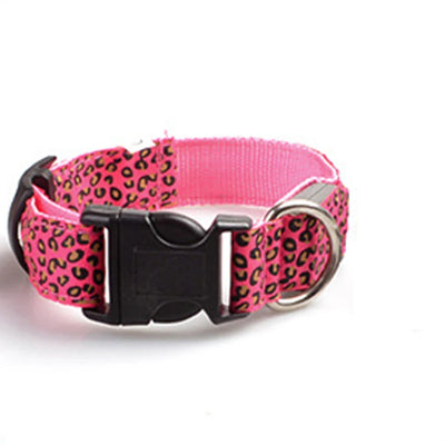 Stylish pink leopard print dog collar with buckle closure and D-ring for leash attachment.