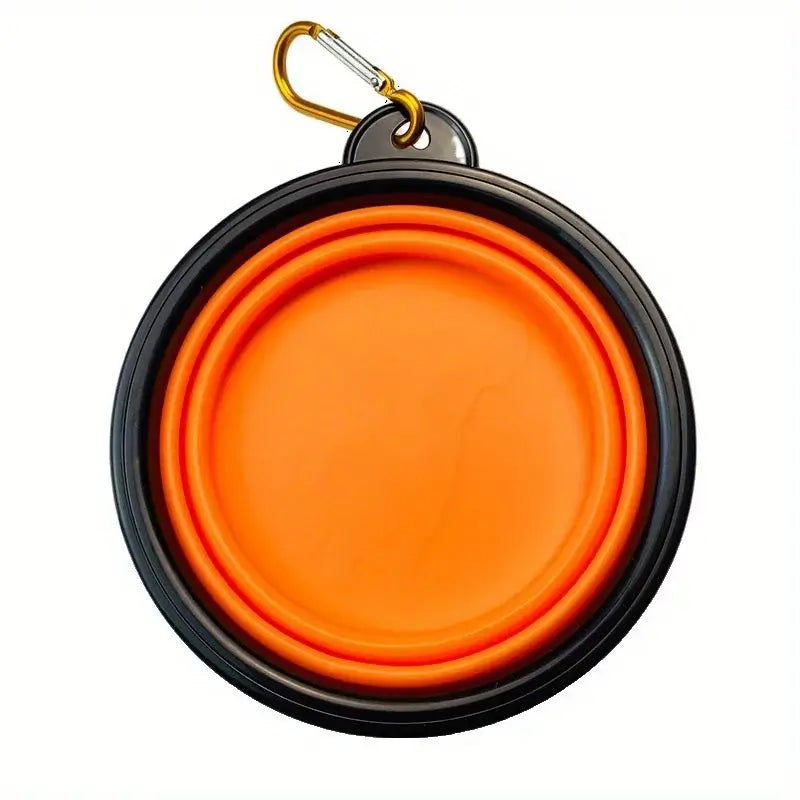 Folding dog bowl for camping in vibrant orange color, portable and lightweight design for outdoor use.