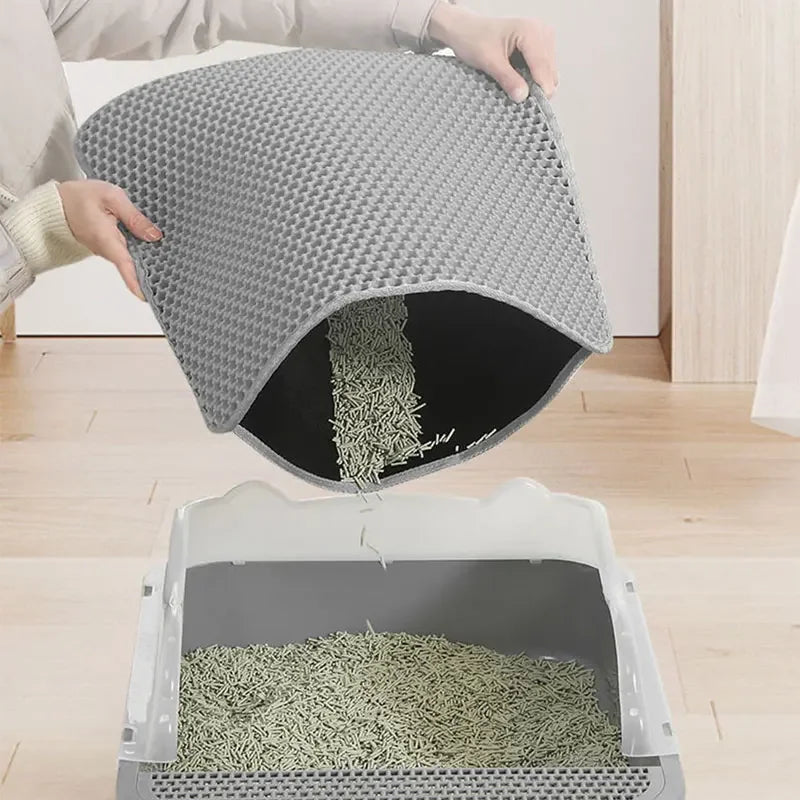 Cat litter mat with honeycomb design, non-slip surface, and a cat walking out of a litter box.