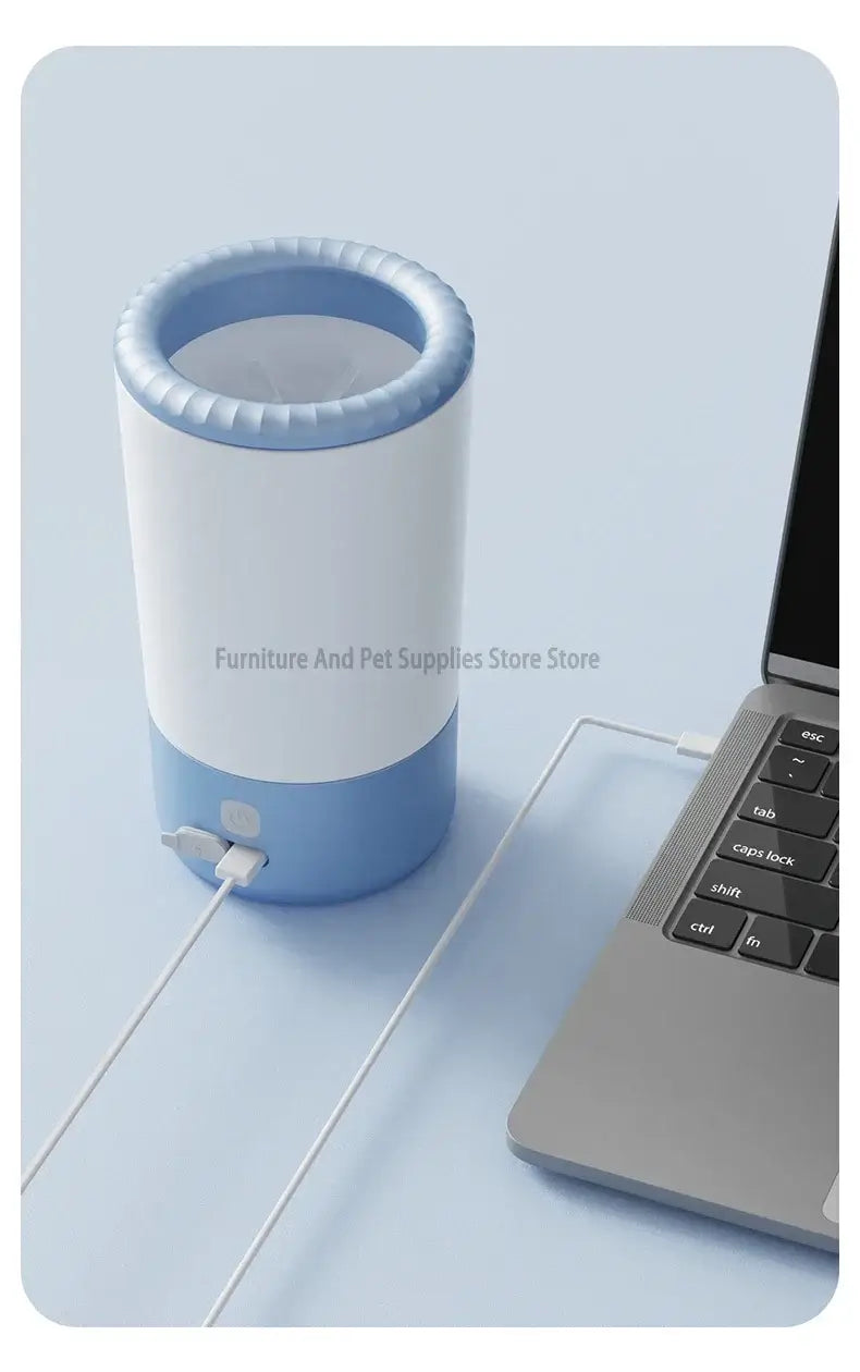 Electric pet paw cleaner charging next to a laptop, illustrating modern pet care technology.