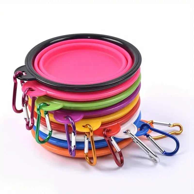 Folding dog bowl for camping, stack of colorful portable bowls with carabiners for easy outdoor use.
