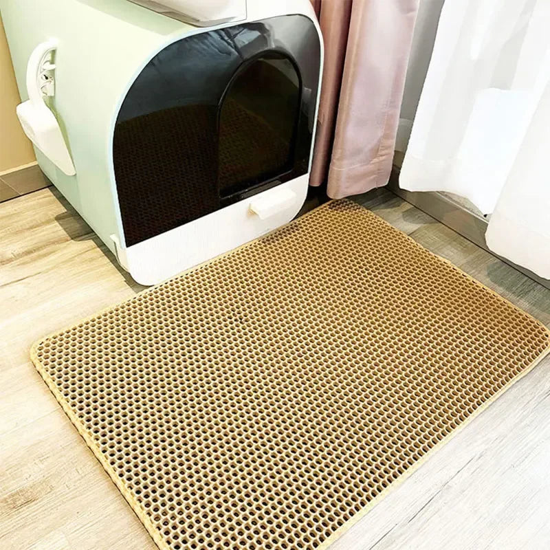 Cat litter mat with honeycomb design, non-slip surface, and a cat walking out of a litter box.
