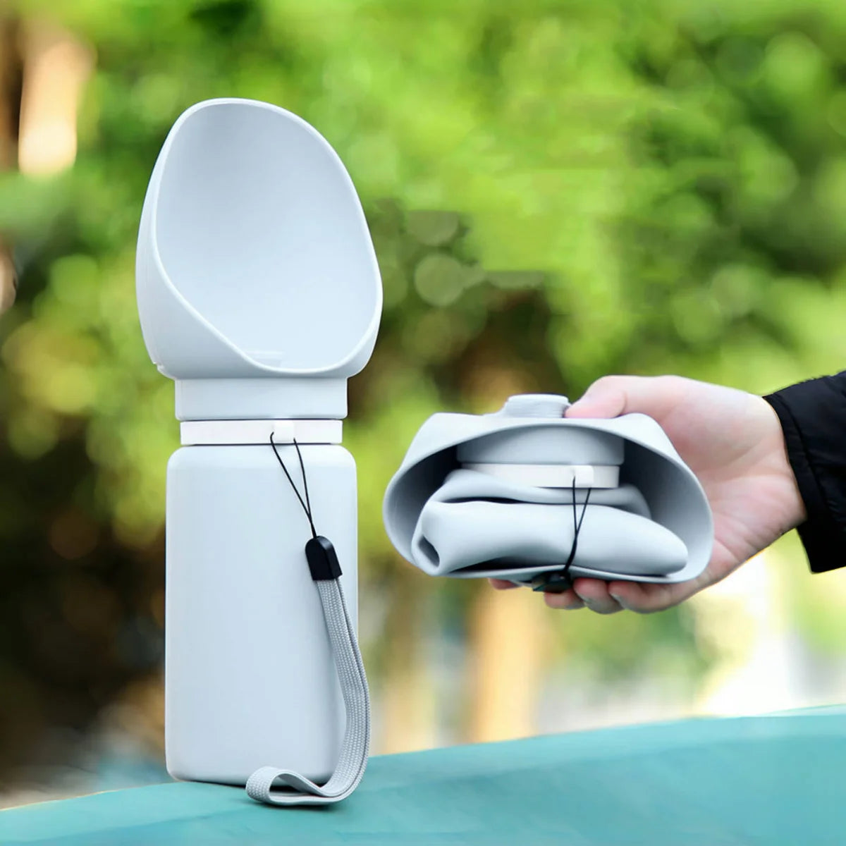 Portable dog water bottle with collapsible cup, perfect for outdoor adventures and hydration.