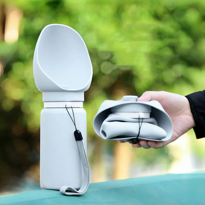 Portable dog water bottle with collapsible cup, perfect for outdoor adventures and hydration.